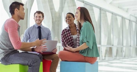 Group of people standing in a circle talking