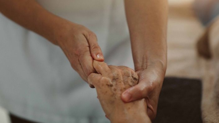 massage therapist massaging client's arm